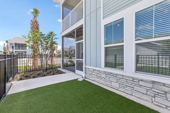 A balcony with a metal railing and a stone wall.